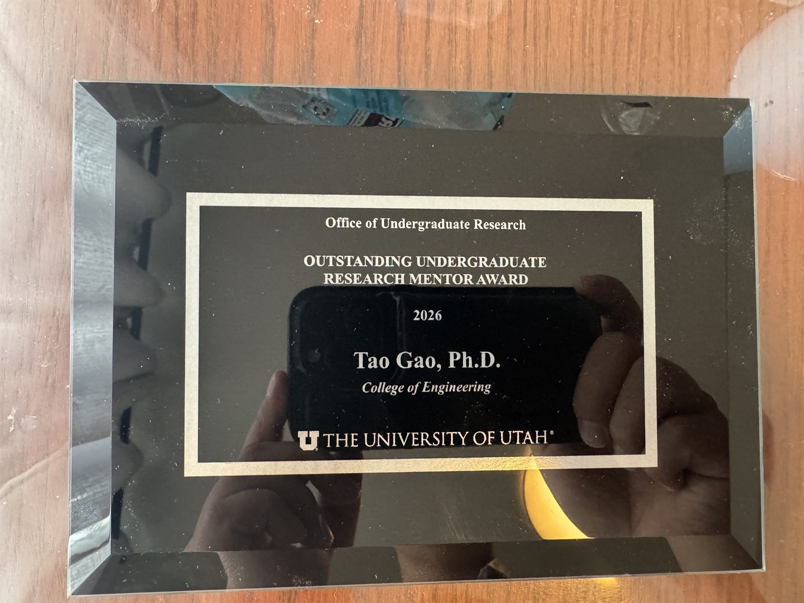 Dr. Gao with the Outstanding Undergraduate Research Mentor Award plaque from the University of Utah, 2026
